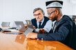 © jaimelafrickmartial  - Two serious interracial businessmen working on an interesting topic , deal with business challenges