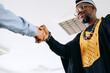 © jaimelafrickmartial  - Two different business partners shaking hands after a negotiation , African American and Caucasian businessmen handshake.