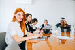 © jaimelafrickmartial  - Multiracial colleagues here an African and a girl with red hair working together while sitting with laptop. I am member of staff of affiliate, preparing creative presentation, teamwork and synergy