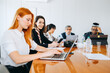 © jaimelafrickmartial  - Multiracial colleagues here an African and a girl with red hair working together while sitting with laptop. I am a member of the staff of the subsidiary, teamwork and synergy concept.