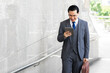 © suphaporn - Portrait Asian business man business walking on business district ,senior visionary executives leader with business vision , tabled phone computer in hand