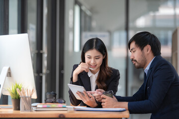 Business professionals. Group of young confident business people analyzing data using a computer while spending time in the office