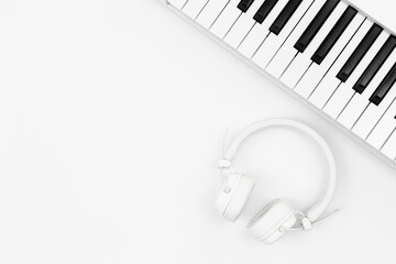 Wall Mural - Music Synthesizer Keyboard and white Music headphone on white, copy space For Music and Sound Production Banner and Poster Advertisement.