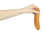 sausage in hand, hand holding out sausage isolated from background, food sharing concept
