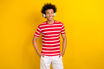 Poster - Photo of pretty cheerful guy wear striped t-shirt earphones enjoying music isolated yellow color background