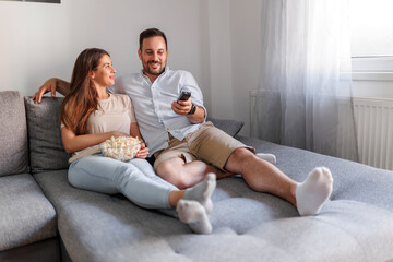 Wall Mural - Couple watching TV and relaxing at home