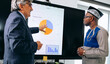 © jaimelafrickmartial  - Two multi ethnic businessmen discuss trading strategy to get better profit on investment by analyzing stock market and currency charts on screen.