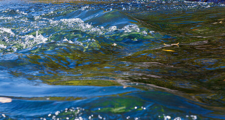 flow of water and spray from a stone