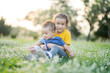 © sripfoto - Little boy and girl sitting on the grass