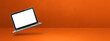 © daboost - Floating computer laptop isolated on orange. Horizontal banner background