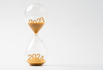 Wall Mural - sand inside of hourglass of change year from 2023 to 2024 for countdown of merry christmas.and happy