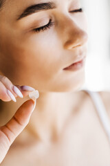 girl with acne round patch on her cheek. young woman using acne patches for treatment of pimple and 