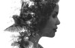 A conceptual black and white paintography portrait of a woman's profile