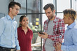 © Katsiaryna - business and technology concept - smiling business team with smartphones in office