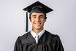 © MVProductions - Portrait of a smiling male valedictorian dressed in black academic dress on a white background, very high honor. Generative AI