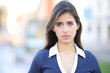 © PheelingsMedia - Sad woman looking at camera in the street