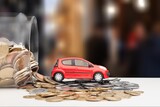Fototapeta Mapy - Small toy car with golden coins