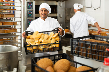 Wall Mural - Portrait of successful baker during daily work in bakeshop