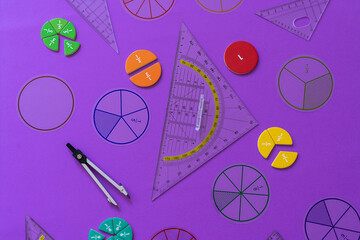 Wall Mural - Fractions, rulers on violet background. Set of supplies for mathematics and for school. Back to school, fun education concept. Geometry background	