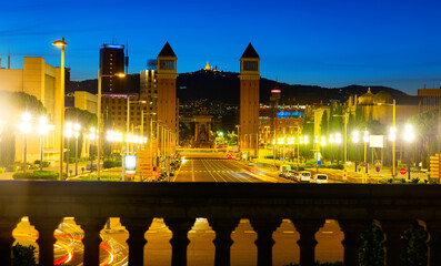 Wall Mural - Picturesque Barcelona cityscape in summer twilight overlooking lighted avenue Avinguda de la Reina Maria Cristina with two Venetian Towers at junction with Placa dEspanya, Spain.