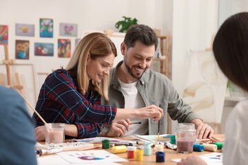 Group of students attending painting class in studio. Creative hobby