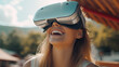 © wetzkaz - VR glasses, virtual reality glasses, goggles, content and happy, young adult woman enjoys a virtual reality travel vacation, fictional place