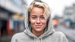 © wetzkaz - young adult female blonde woman, slender slim attractive beauty, blond hair, light gray hoodie, outdoor free time or weekend or afternoon or vacation or city stroll, fictional location