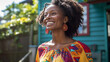 © wetzkaz - young adult african american or african black dark skinned woman with a smile and an updo wearing traditional colorful clothing in a fictional town