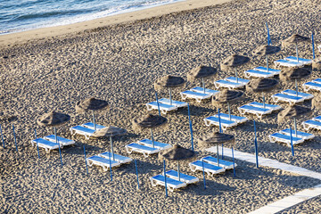 Wall Mural - Blue and white beach chairs  in a row on a sandy beach