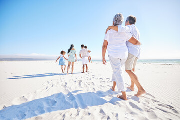 Canvas Print - Big family, sea or old couple walking with kids in summer with happiness, trust or peace in nature. Grandparents, back view or senior man bonding with woman or children taking a walk on beach sand