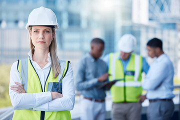 Poster - Portrait, arms crossed and a serious woman construction worker outdoor on a building site with her team in the background. Management, leadership and a confident female architect standing outside