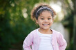 © Siphosethu Fanti/peopleimages.com - Happy, smile and portrait of a kid in a garden with joy, positive emotion and childhood growth. Happiness, excited girl and face of cute child from Mexico standing outdoor in park with mockup space