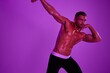 © SHOTPRIME STUDIO - Man athletic body bodybuilder in briefs with nude torso abs full-length in the background fitness classes, purple colored light. Advertising, sports, active lifestyle, competition, challenge concept.