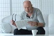 © aletia2011 - Senior old man reading newspaper at home