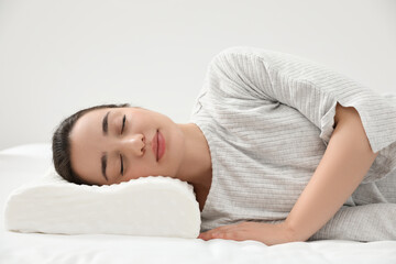 Woman sleeping on memory foam pillow indoors