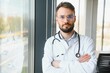 © Serhii - happy male medical doctor portrait in hospital