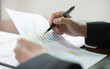© Orathai - The businessman hand sits at their desks and calculates financial graphs showing the results of their investments planning the process of successful business growth