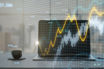 Poster - Close up of laptop at workplace with coffee cup and glowing candlestick forex chart on blurry background. Trade, finance and technology concept. Double exposure.