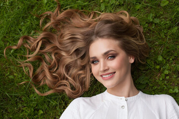 Wall Mural - beautiful woman enjoying summer on green grass outdoors