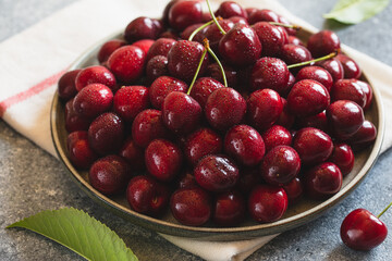 Wall Mural - Composition of sweet cherries on a plate with water drops. Summer and harvest concept. Cherry macro. Vegan, vegetarian, raw food