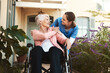 © Chanelle Malambo/peopleimages.com - Senior woman, wheelchair and nurse in healthcare support, talking or garden walk at nursing home. Happy elderly female and caregiver helping patient or person with a disability, health or retirement
