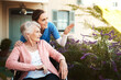 © Chanelle Malambo/peopleimages.com - Senior woman, wheelchair and nurse in garden pointing and talking on walk in healthcare support at nursing home. Happy elderly female or caregiver showing patient or person with a disability outdoors
