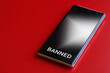 © slexp880 - Modern mobile phone is a smartphone with the inscription 'banned' on a red background. The concept of a ban on the use of a smartphone, cellular communication and gadgets. Photo.