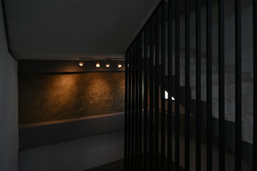 The way up and down the stairs is lit up by a loft-style wall.