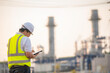 © reewungjunerr - Asian man petrochemical engineer working at oil and gas refinery plant industry factory,The people worker man engineer work control at power plant energy industry manufacturing