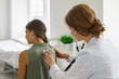 © Studio Romantic - Girl in the clinic for a medical checkup. Female doctor with stethoscope examining child's lungs, breathing and heartbeat at the hospital. Pediatrician checking a young patient in exam room.