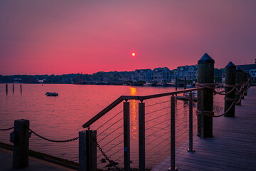 Wall Mural - Sunrise over the deck, mooring boat, and wildfire smoke over the Mystic River marina in Connecticut