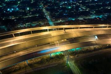 Poster - Aerial view of american freeway intersection at night with fast driving cars and trucks in Tampa, Florida. View from above of USA transportation infrastructure