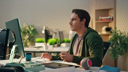 Wall Mural - Pensive freelancer watching screen at office. Graphic designer holding stylus