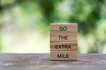Wall Mural - Wood block with text - Go the extra mile